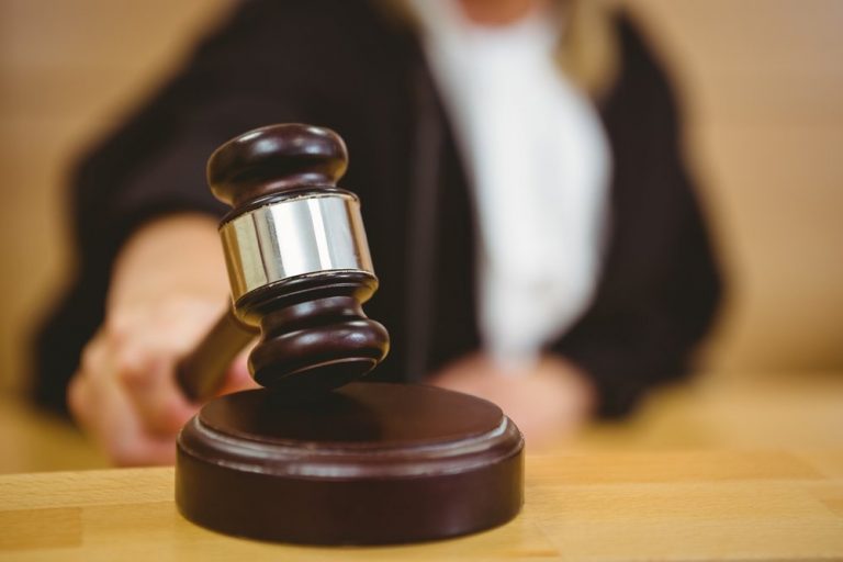 hand about to bang gavel on sounding block